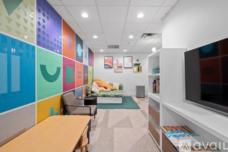 A brightly colored office space with a variety of furniture and decorations.