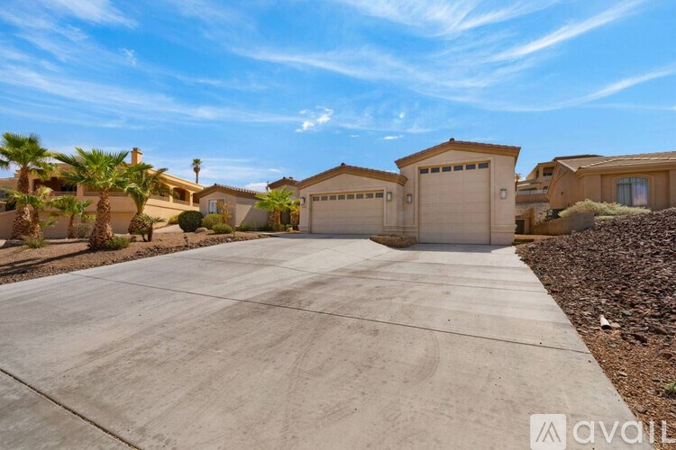 A sunny day in a residential area with houses and palm trees.