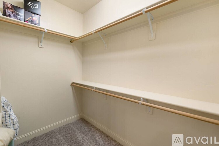 A room with a white wall and a wooden shelf.
