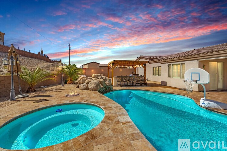 A pool with a basketball hoop in the middle of it.