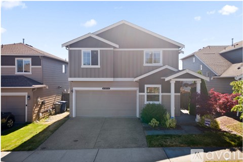 A house with a garage is for sale.