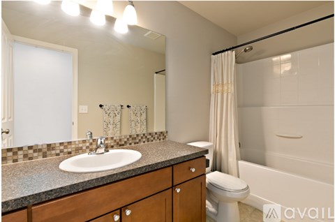 A bathroom with a sink, toilet, and bathtub.