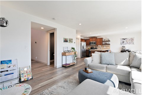 A living room with a white couch and a coffee table.