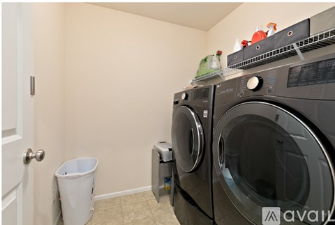 A washing machine and dryer in a small laundry room.