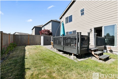 A house with a deck and a fence.