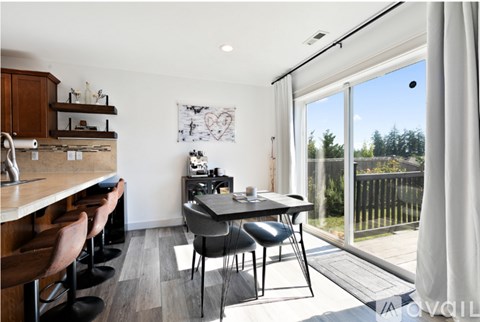 A modern kitchen with a dining table and chairs.