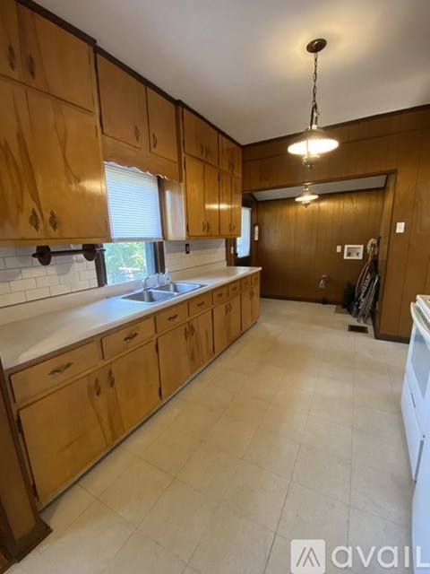 A kitchen with wooden cabinets and a white countertop.