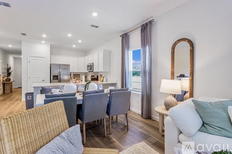 A well-lit, modern kitchen and dining area with a view of the city.
