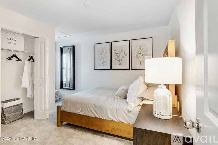 A bedroom with a bed, nightstand, and a lamp.