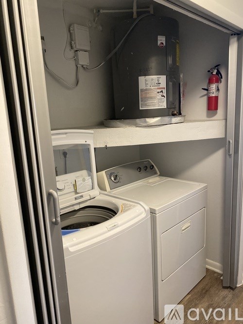 A white washing machine and dryer in a small laundry room.