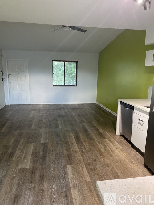 A room with wooden flooring and a green wall.