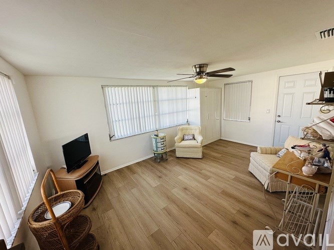 A living room with a television, a chair, and a table.