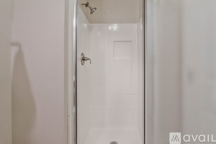 A white door with a silver handle and a small square on the door.