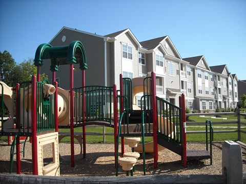 a playground with apartments in the background