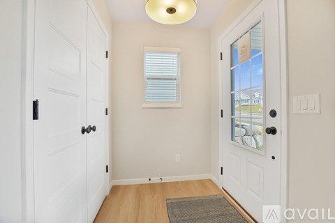A white door with a black handle is on the left side of the image.