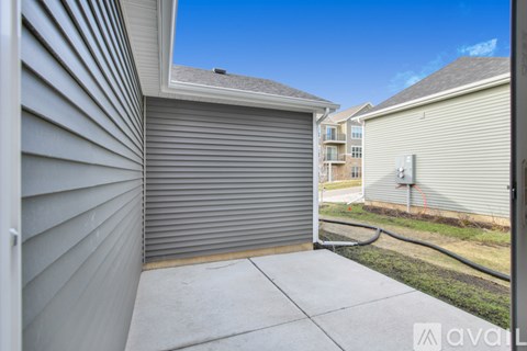 A sunny day at a residential area with a closed grey garage door.