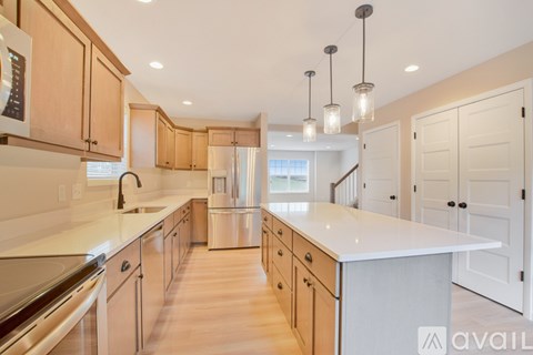 A kitchen with wooden cabinets and a white countertop.