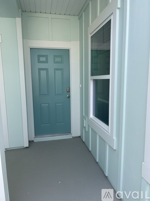 A blue door is on the left and a window is on the right.