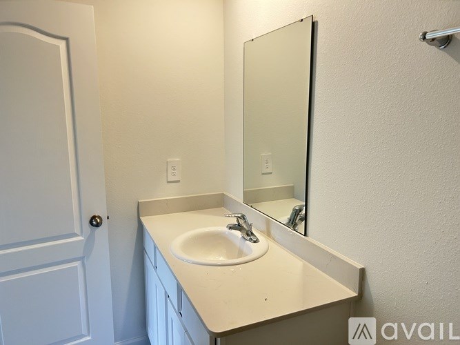A bathroom with a sink and mirror.