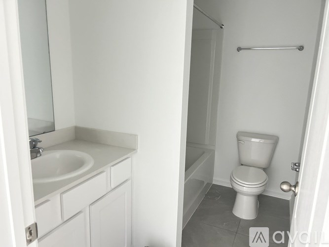 A white bathroom with a toilet and sink.