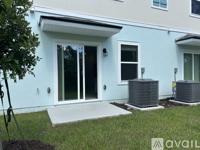 A white house with a blue trim and a white door.