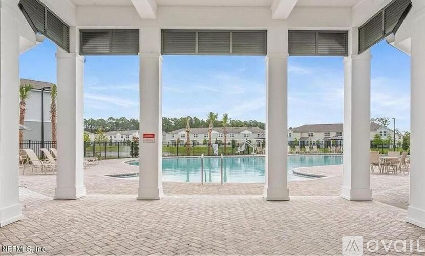 A pool area with a white column and a red sign.