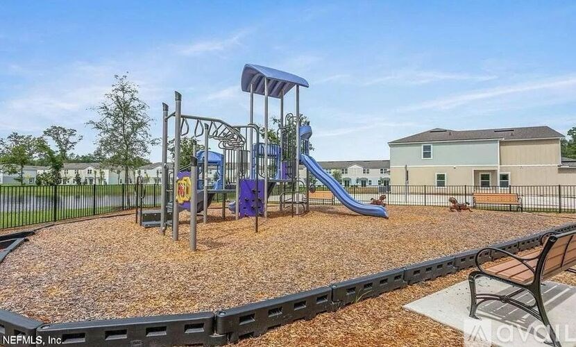 A playground with a slide and a climbing frame.