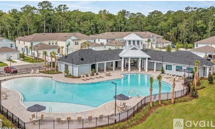 A large house with a pool in front of it.