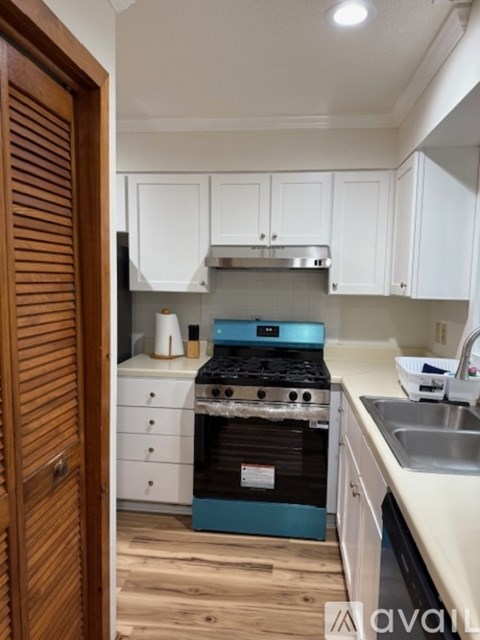 A kitchen with a stove and cabinets.