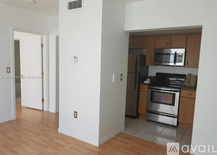 A kitchen with a stove top oven and microwave above it.