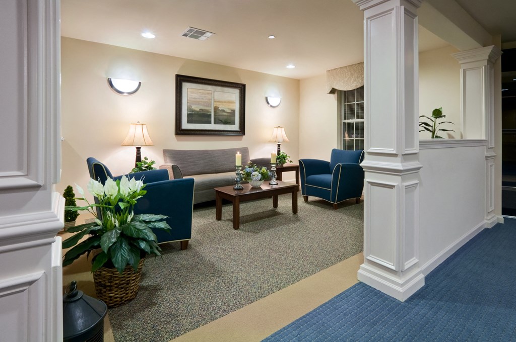 a living room with couches chairs and a table