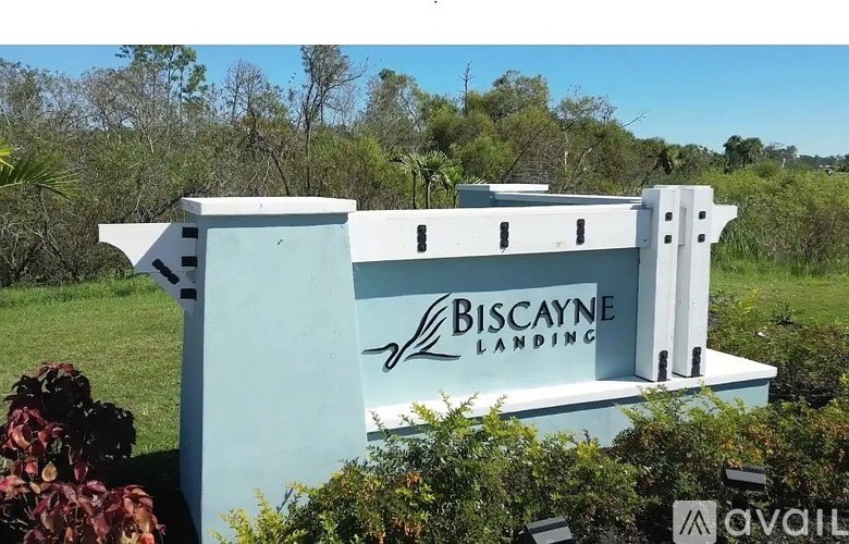 A sign for Biscayne Landing is shown in front of a green landscape.