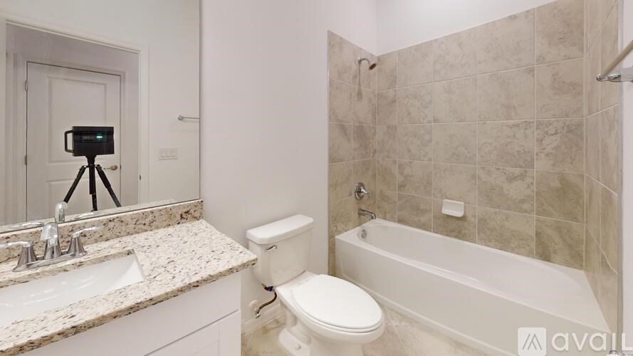 A bathroom with a toilet, sink, and bathtub.