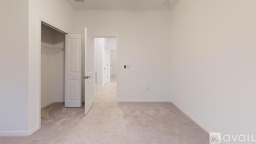 A room with a white door and a white cabinet.