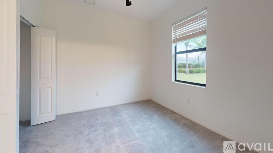 A room with a window and a door is available for rent.