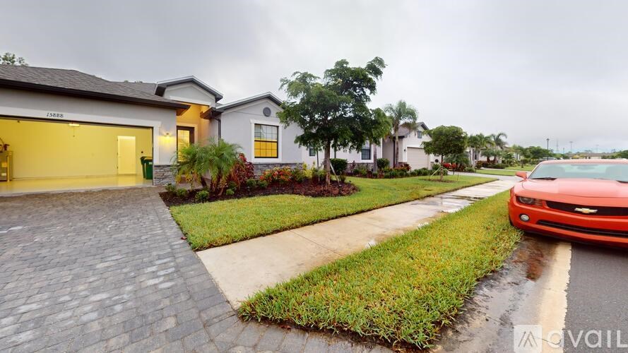 A red car is parked on the side of a street.