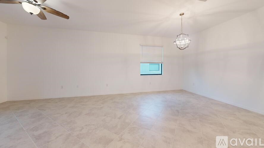 A room with a ceiling fan and a hanging light fixture.
