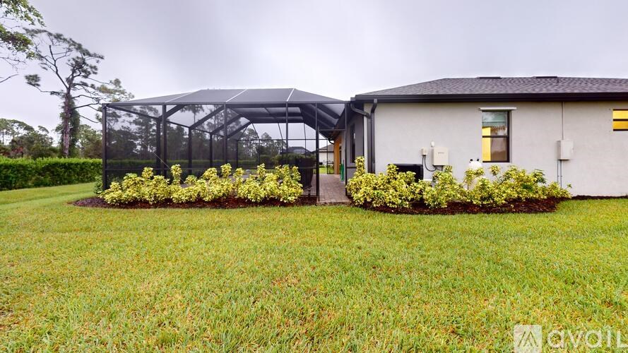 A house with a garden and a greenhouse.