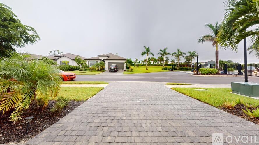 A red car is parked in front of a house.