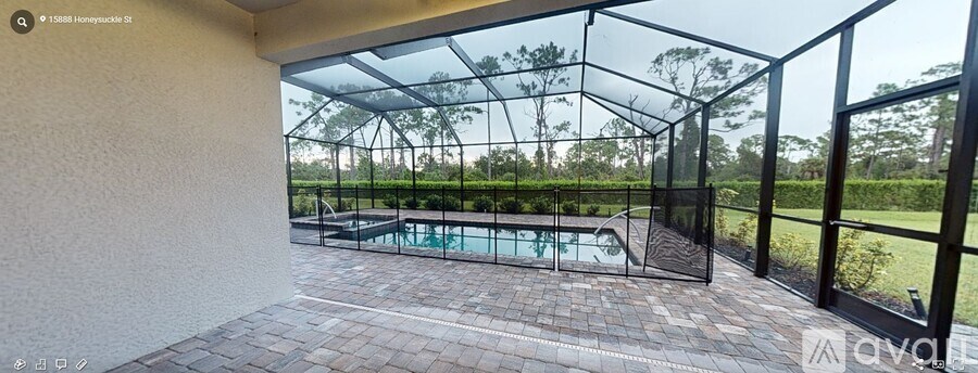 A glass-walled room with a pool in the background.