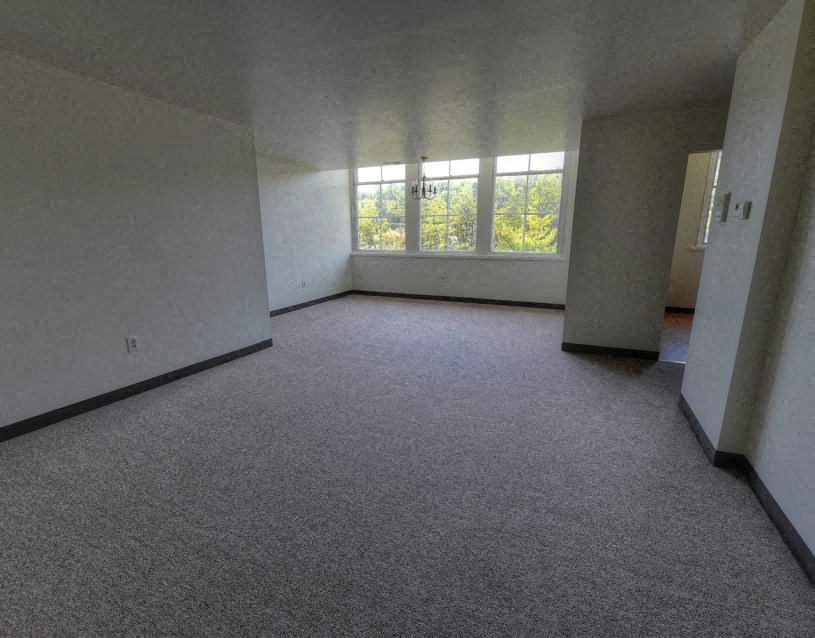an empty living room with a large window
