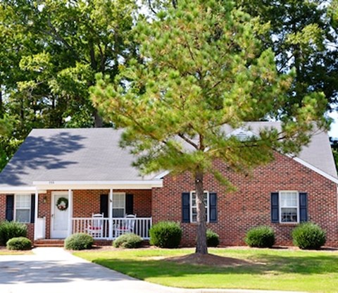 A house with a tree in front of it.