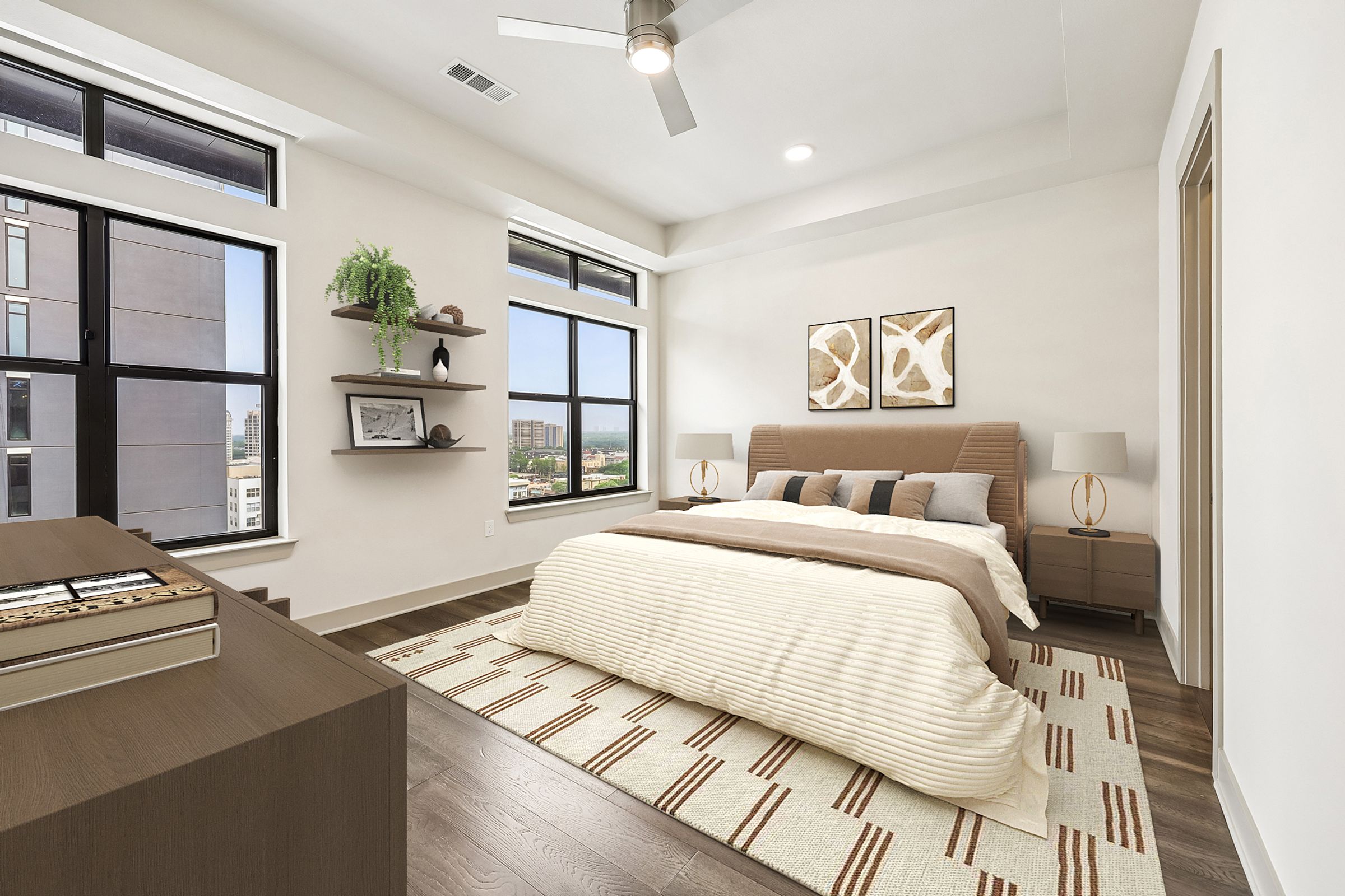 A bedroom with a large bed and a window overlooking the city.