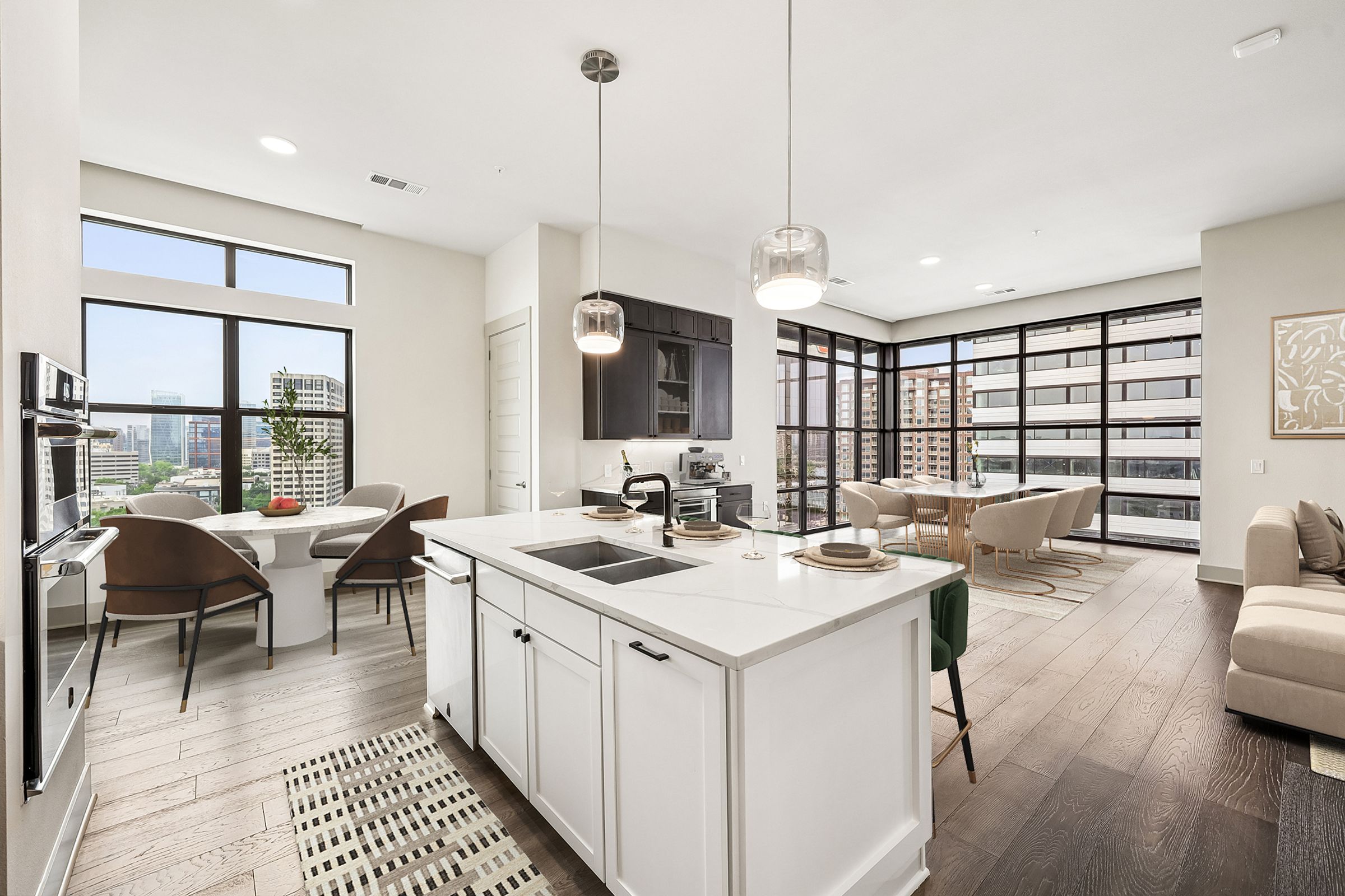 A modern kitchen with white cabinets and a large island.