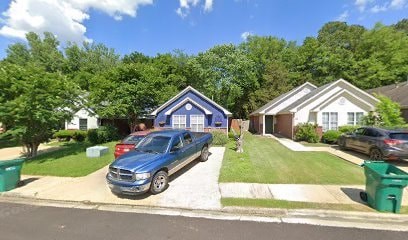 A blue house with a car parked in front.