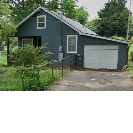 A blue house with a white garage door.