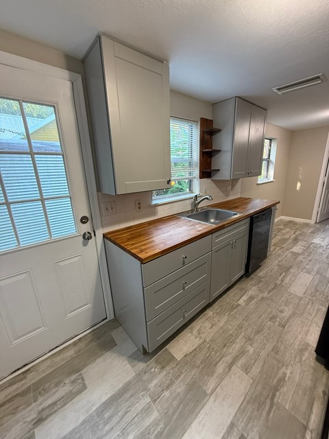 A kitchen with a sink and cabinets.