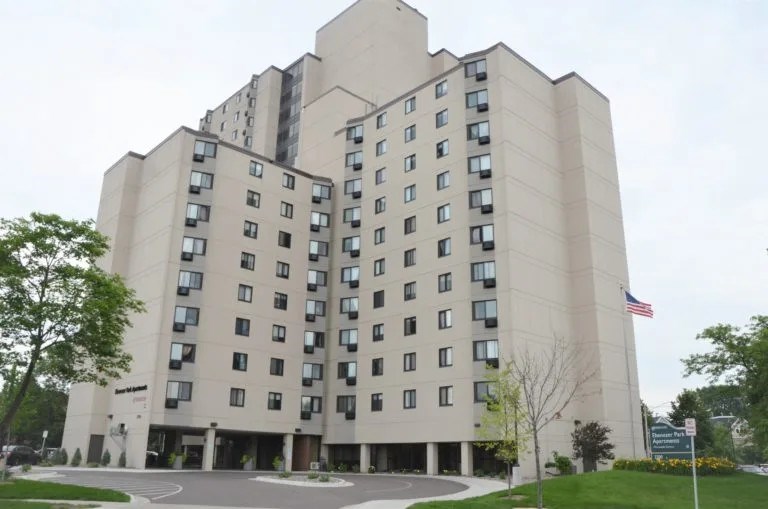 A large beige building with a flag on the right side.