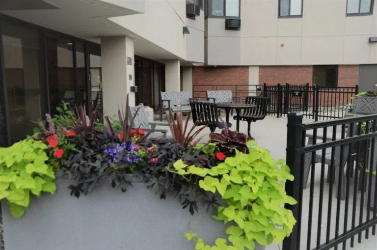 A black metal fence is in front of a building.