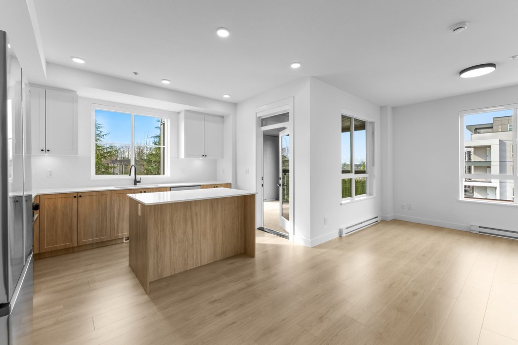 A modern kitchen with wooden cabinets and a large island.